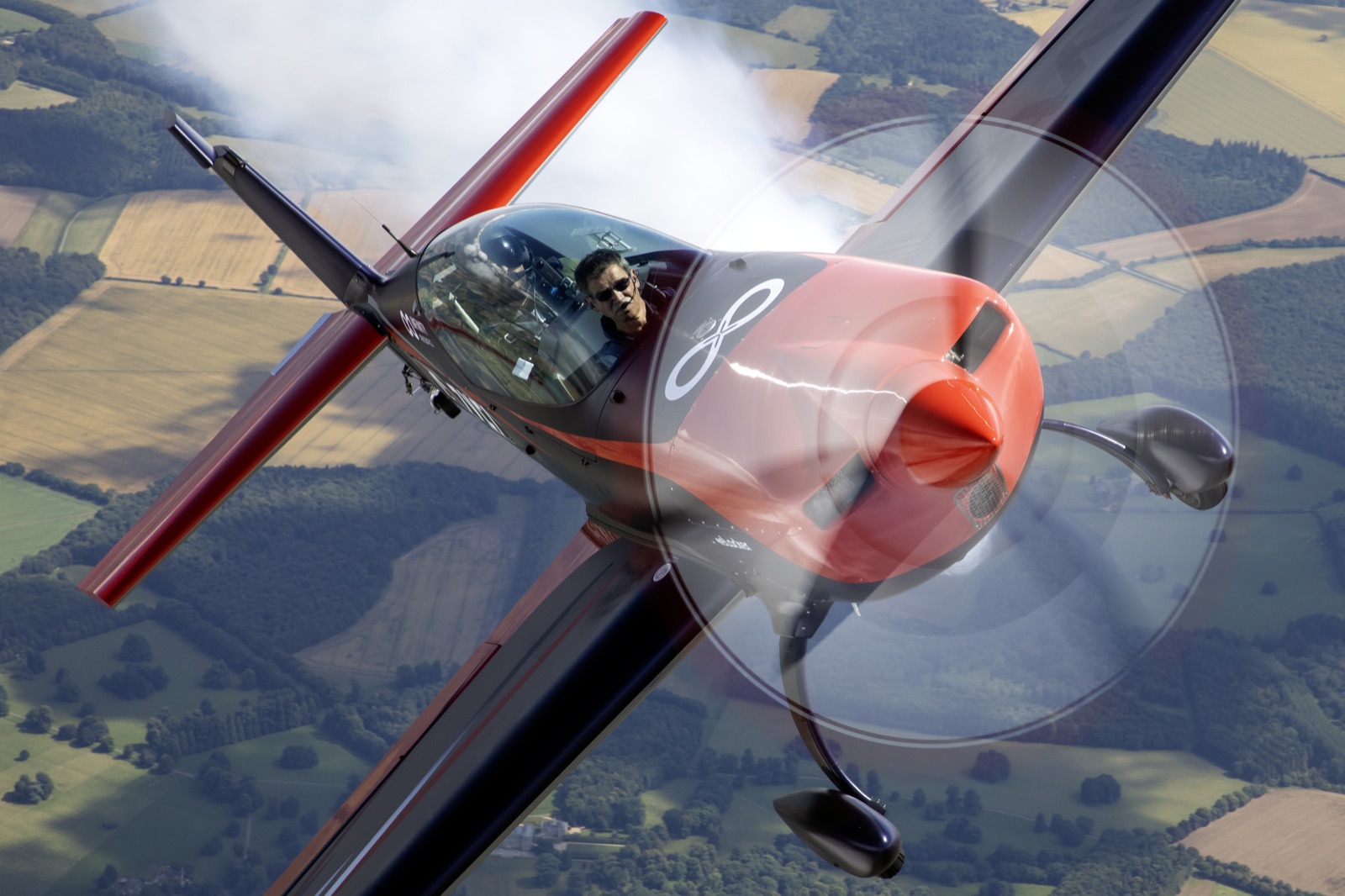 The Extra 300 front-quarter view passing through cloud