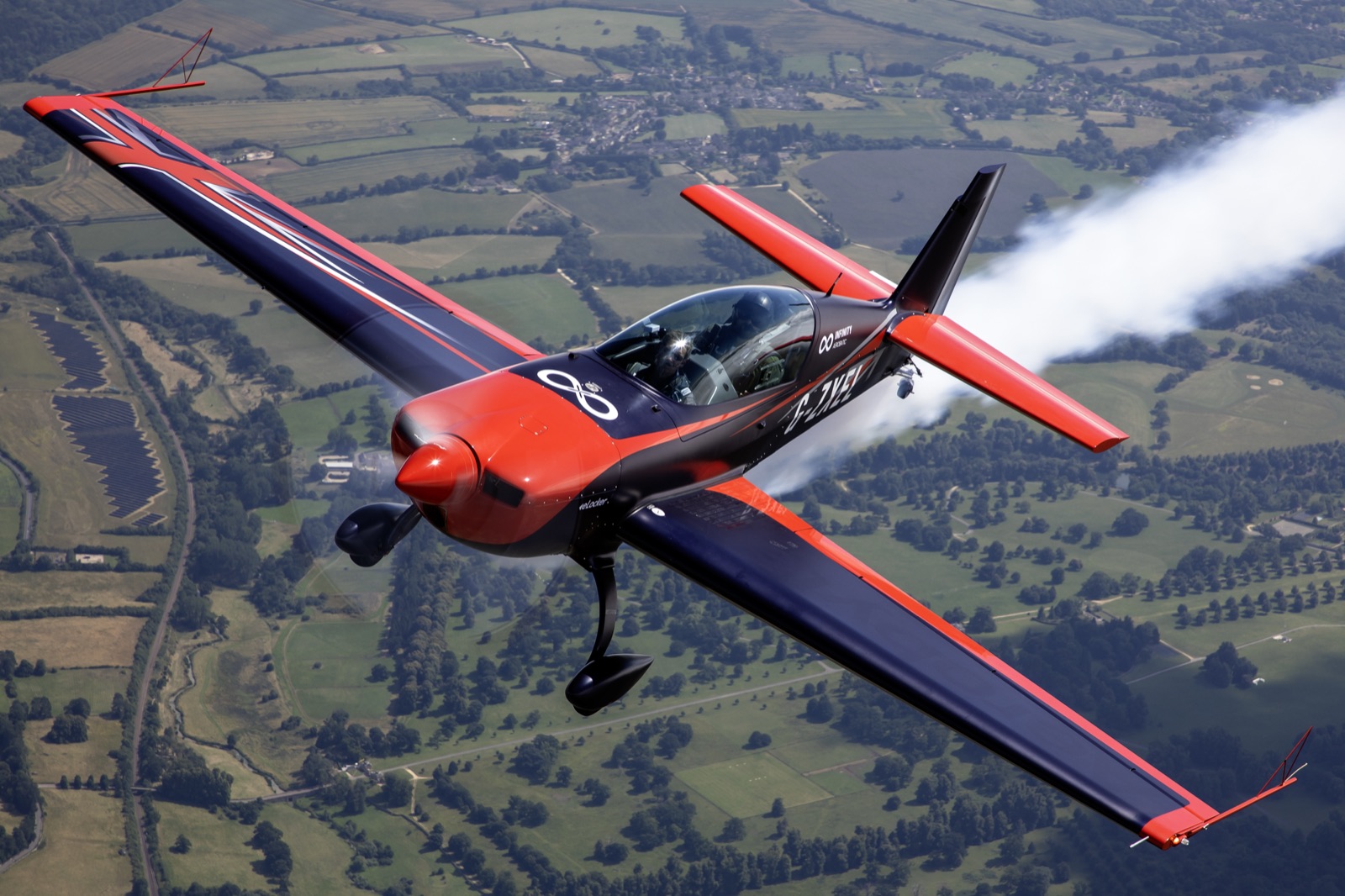 A moody low-light pass with smoke trailing behind the Extra 300