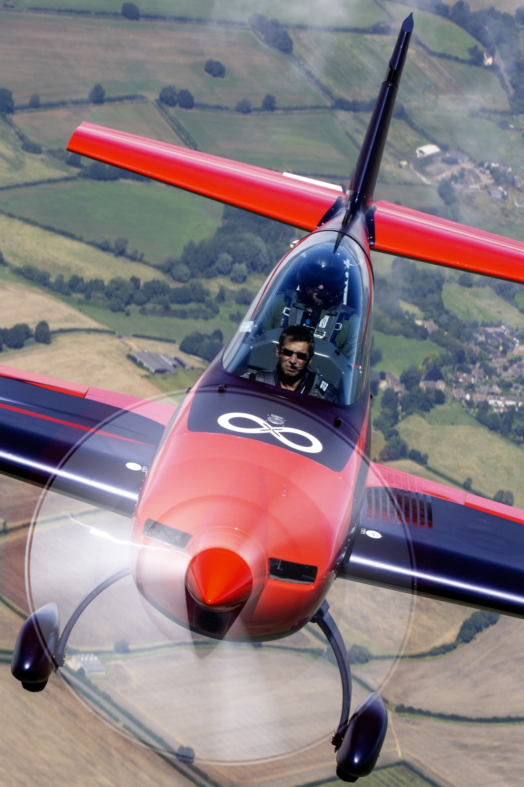 Front-on view of the Extra 300 trailing smoke