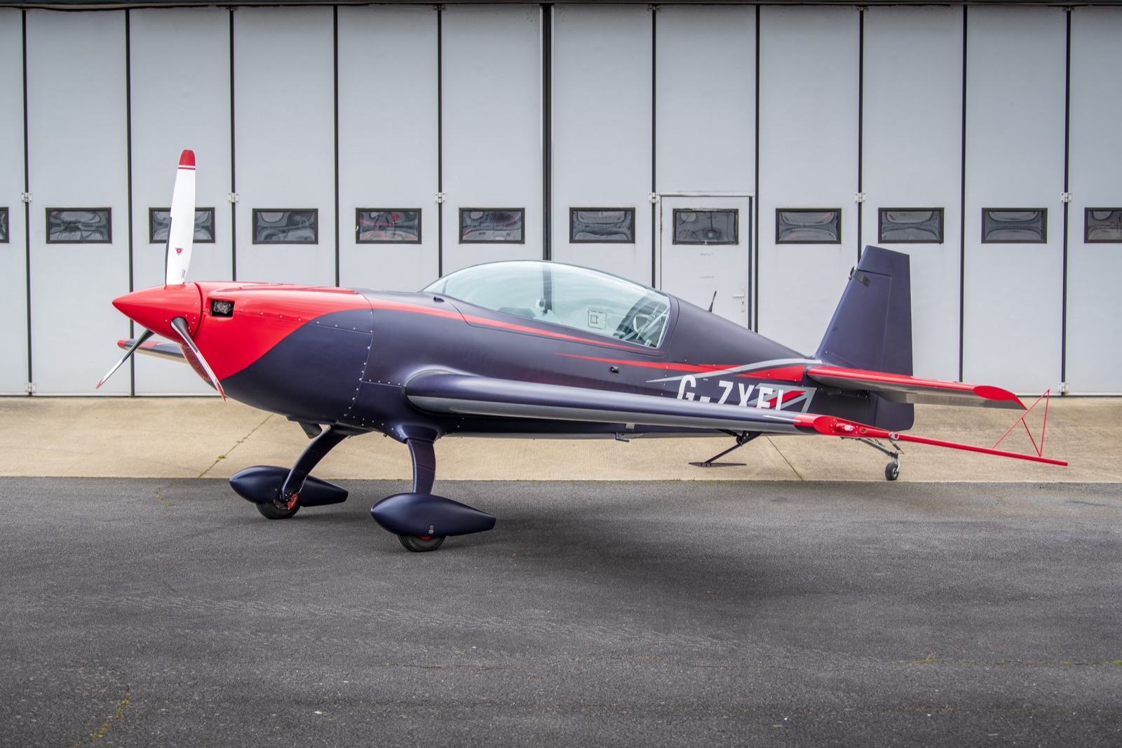 The Extra 300 (G-ZXEL) parked outside the hangar, three-quarter view
