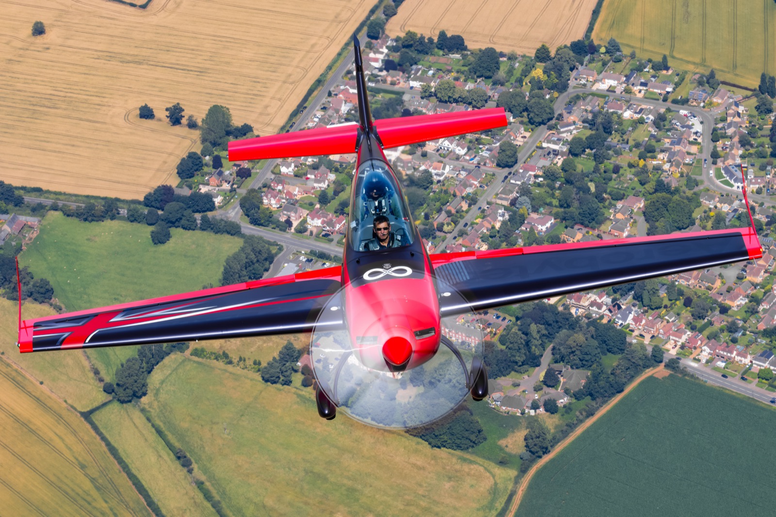 The Extra 300 from above with villages and fields below