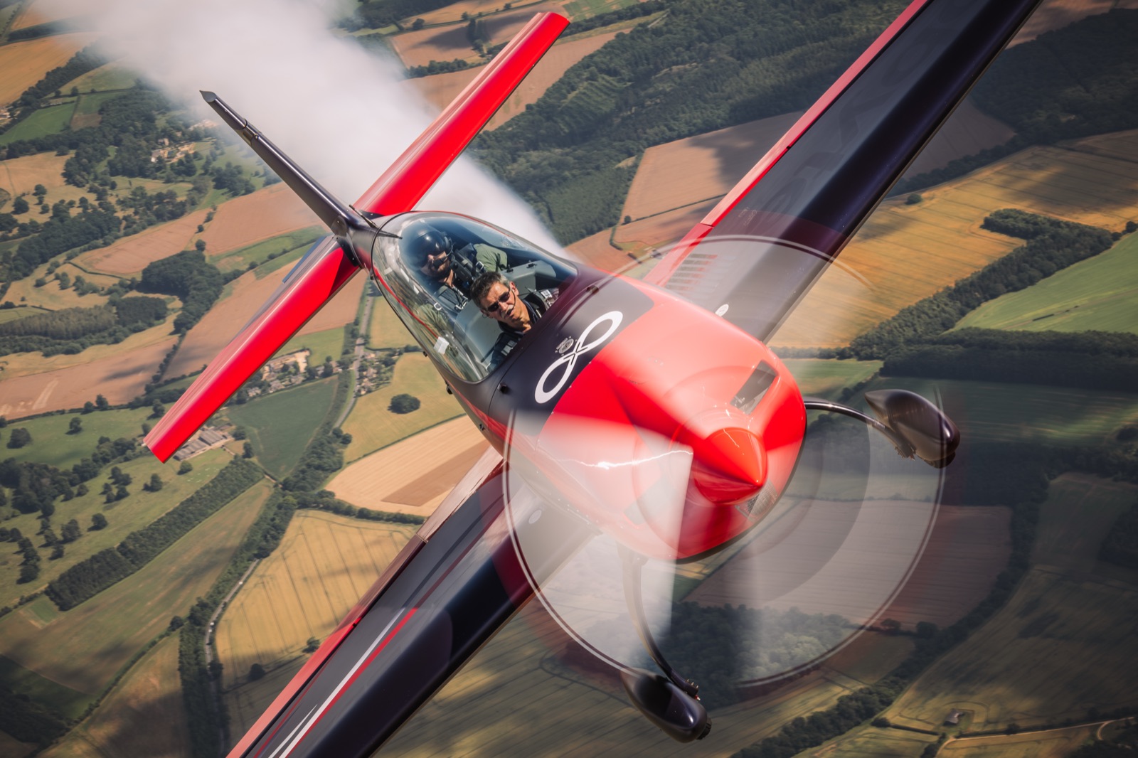The Extra 300 emerging from a cloud of its own smoke